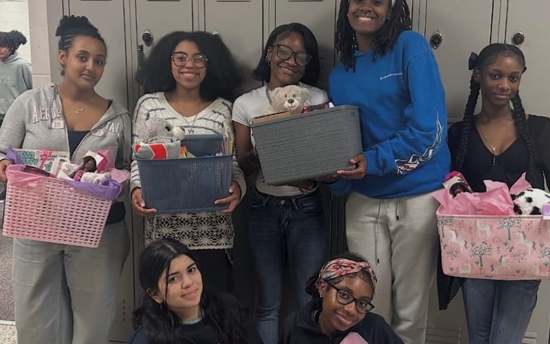 Student volunteers assembling care packages